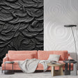 Black 3D feather textured wallpaper in modern living room with natural lighting highlighting the relief pattern