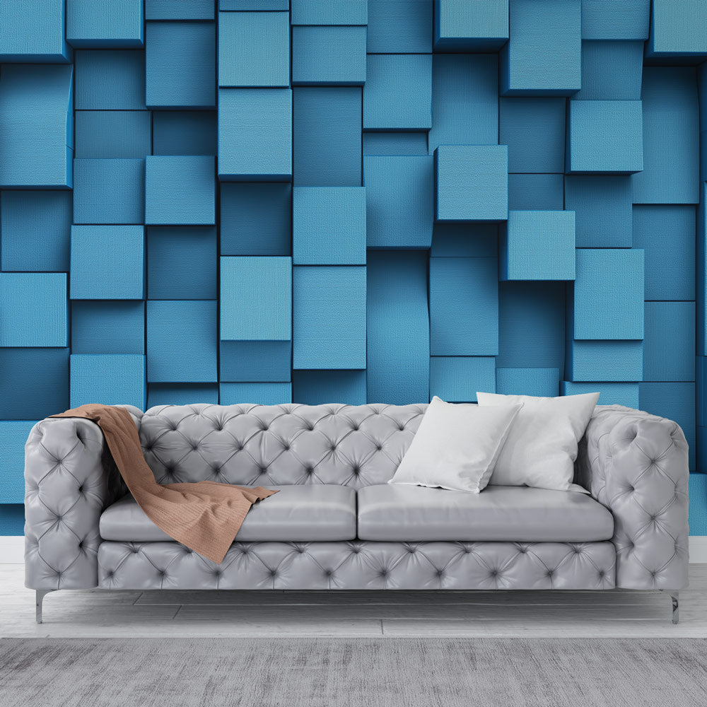 Modern blue 3D cube wallpaper creating depth in a minimalist living room with natural lighting