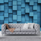 Modern blue 3D cube wallpaper creating depth in a minimalist living room with natural lighting