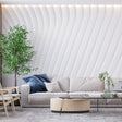 White 3D wave wallpaper creating depth in a modern living room with minimalist furniture