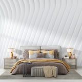 3D wave pattern wallpaper making a bedroom look bigger with soft natural lighting