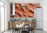 Dining area with sculptural 3D wallpaper in warm terracotta tones