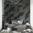 Black 3D leaf wallpaper in modern living room with grey sofa and pendant lights
