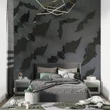 Black 3D leaf wallpaper in modern living room with grey sofa and pendant lights