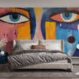 Abstract face mural wallpaper bringing urban art style to a modern living room with dramatic lighting and minimalist furniture