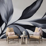 Black and white botanical wallpaper creating dramatic impact in modern living room with tall windows and minimal furniture