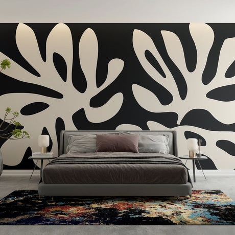 Modern black and white foliage wallpaper creating dramatic contrast in a minimalist living room setting