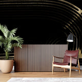 Black and gold curved line wallpaper in modern living room creates dramatic accent wall