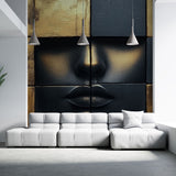 Black and gold abstract face mural wallpaper creating dramatic impact in modern living room with grey sofa and pendant lights