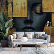 Black and gold geometric face wallpaper creating dramatic impact in a modern living room with high ceilings