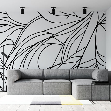 Abstract line art wallpaper creating dramatic impact in a modern living room with minimalist furniture