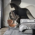 Abstract black and white silhouette wallpaper creating dramatic impact in a modern living room with minimalist furniture