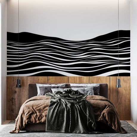 Black wave pattern wallpaper creating dramatic effect in a modern minimalist living room with white furniture