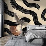 Modern abstract wave wallpaper creating dramatic impact in a minimalist living room with black and cream contrasts