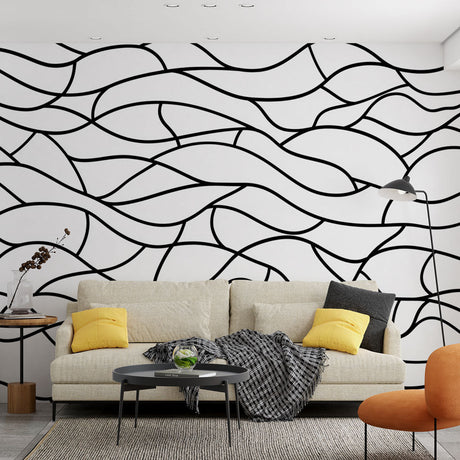 Black wave abstract wallpaper creating dramatic impact in a modern minimalist living room with white furniture