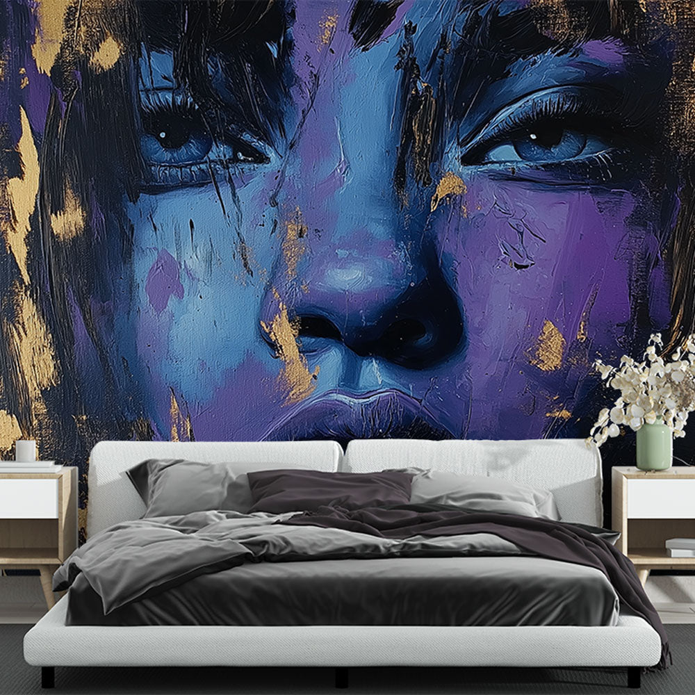 Abstract portrait wall mural in blue and gold tones creating drama in a modern living room with minimalist furniture