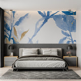 Blue and gold watercolor leaf wallpaper in modern living room with grey sofa and natural light