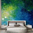 Abstract watercolor wallpaper in blue and green tones creating a calming atmosphere in a modern living room setting