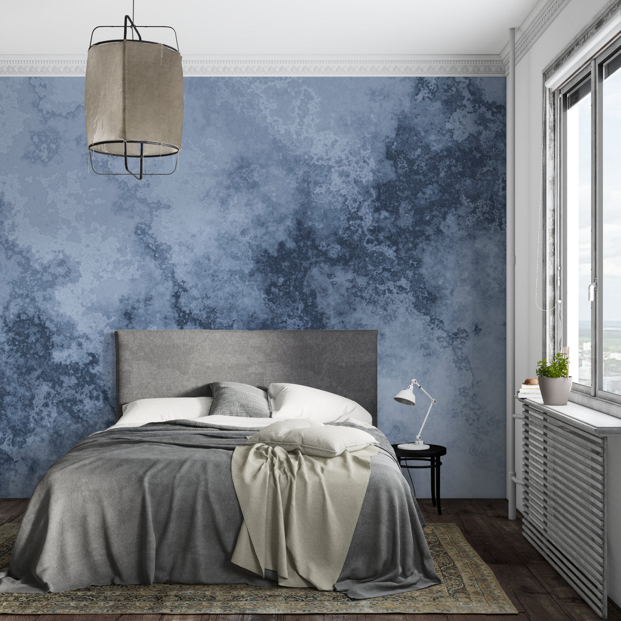 Blue and grey abstract watercolor wallpaper creating a peaceful atmosphere in a modern living room setting