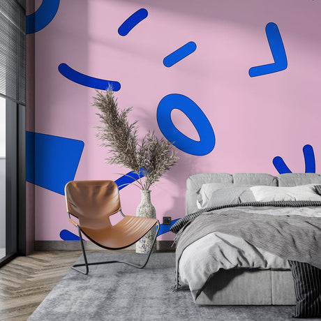 Modern pink and blue geometric wallpaper creating a bold statement in a bright minimalist living room setting