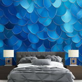 Modern blue metallic scale wallpaper creating depth in a minimalist living room with natural light