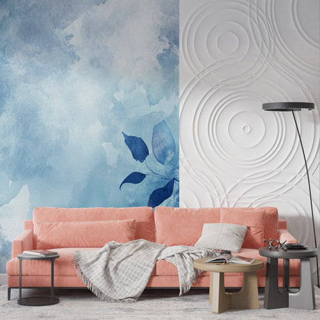 Blue watercolor leaves mural wallpaper in a bright modern living room with natural light streaming through windows