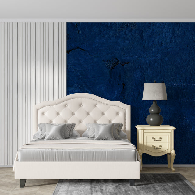 Deep blue abstract wallpaper creating dramatic accent wall in modern living room with minimalist furniture