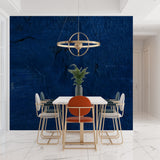 Modern office space featuring deep blue abstract wall mural behind desk
