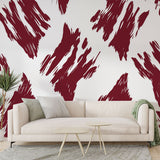 Abstract red brush stroke wallpaper creating dramatic impact in a modern living room with white furniture