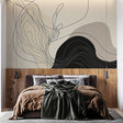 Abstract line art wallpaper creating a modern focal point in a minimal living room with black and beige flowing patterns