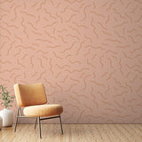Abstract line wallpaper with terracotta flowing pattern shown in a modern minimalist living room setting