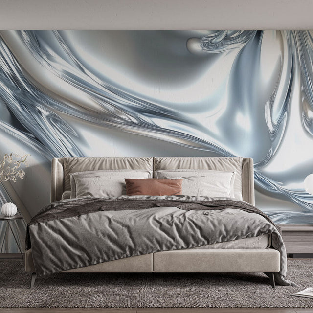 Silver abstract wallpaper creating depth in a modern living room with natural light highlighting the metallic waves