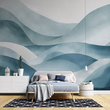 Abstract wave wallpaper creating a serene atmosphere in a modern living room with minimalist furniture