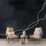 Modern abstract line wallpaper creating dramatic contrast in a minimalist living room with white furniture