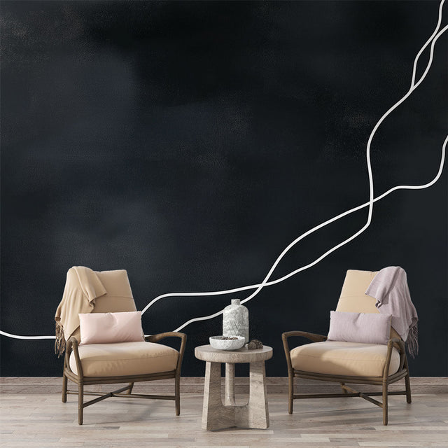 Modern abstract line wallpaper creating dramatic contrast in a minimalist living room with white furniture