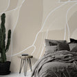 Abstract line wallpaper creating a serene atmosphere in a modern minimalist living room with beige and white flowing patterns