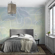 Abstract curve wallpaper creating a calm atmosphere in a modern living room with grey sofa and natural light