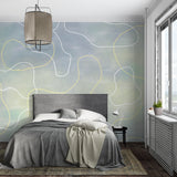 Abstract curve wallpaper creating a calm atmosphere in a modern living room with grey sofa and natural light