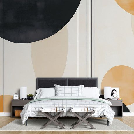 Modern geometric wallpaper with black and gold circles creating depth in a minimalist living room setting