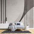 Modern geometric wallpaper with clean lines and curves creates striking impact in a minimalist living room setting
