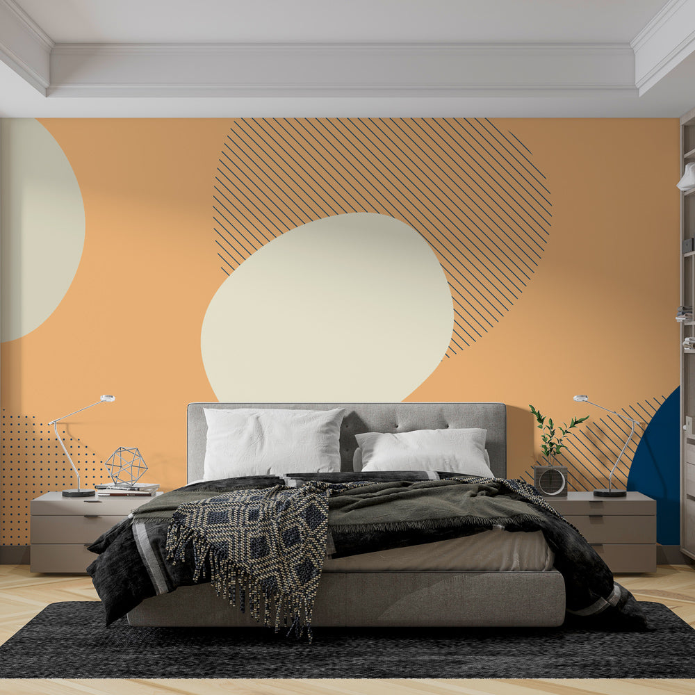 Modern geometric abstract wallpaper with peach and navy circles shown in a bright contemporary living room setting