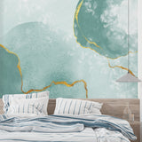 Modern living room with mint green and gold abstract wallpaper creating a fresh, airy atmosphere