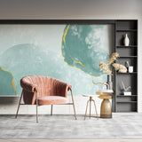 Bedroom featuring gold veined mint green wallpaper with soft morning light