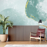 Home office with abstract mint green and gold wallpaper accent wall