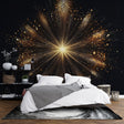Black and gold starburst wallpaper creates dramatic impact in modern living room with grey sofa and minimal decor