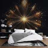 Black and gold starburst wallpaper creates dramatic impact in modern living room with grey sofa and minimal decor