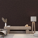 Modern brown wave pattern wallpaper displayed in a minimalist living room, creating a sophisticated focal wall