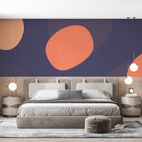 Modern abstract coral wallpaper in bright living room setting with grey sofa and natural light