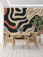 Modern abstract wallpaper with black curves in bright living room setting, natural light highlighting terracotta accents