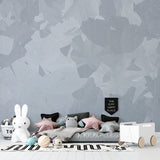 Modern grey geometric wallpaper adding sophistication to a master bedroom